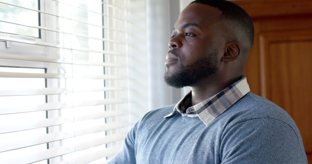 Thoughtful Black Man Looking Out of Window Shirt - Free Images, Stock Photos and Pictures on Pikwizard.com