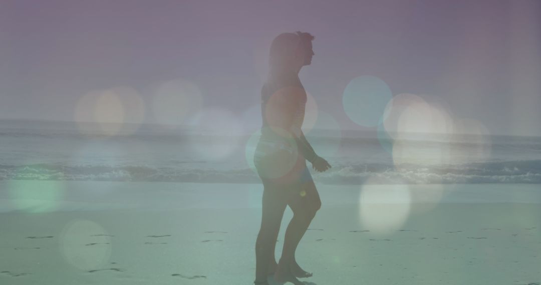 Silhouette Couple Walking on Beach with Dreamy Lens Flares
