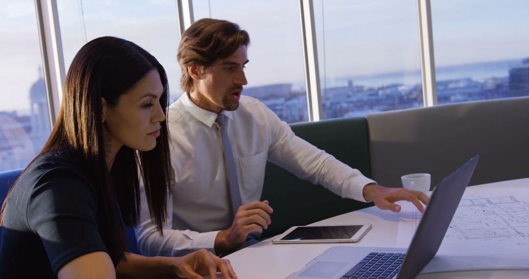 Business Professionals Analyzing Reports in Modern Office Space