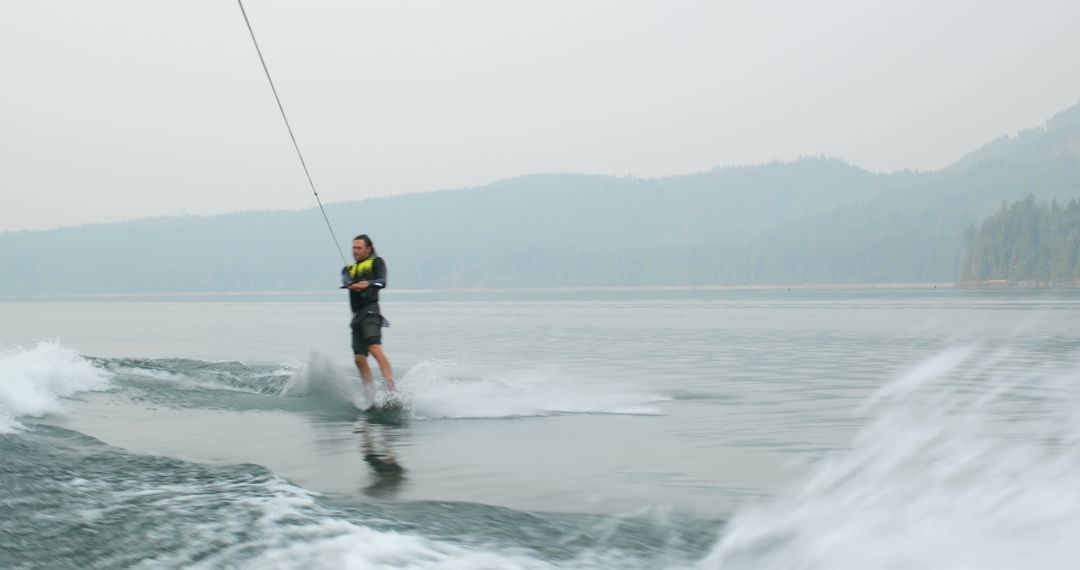 Woman Wakeboarding on Misty Lake - Free Images, Stock Photos and Pictures on Pikwizard.com