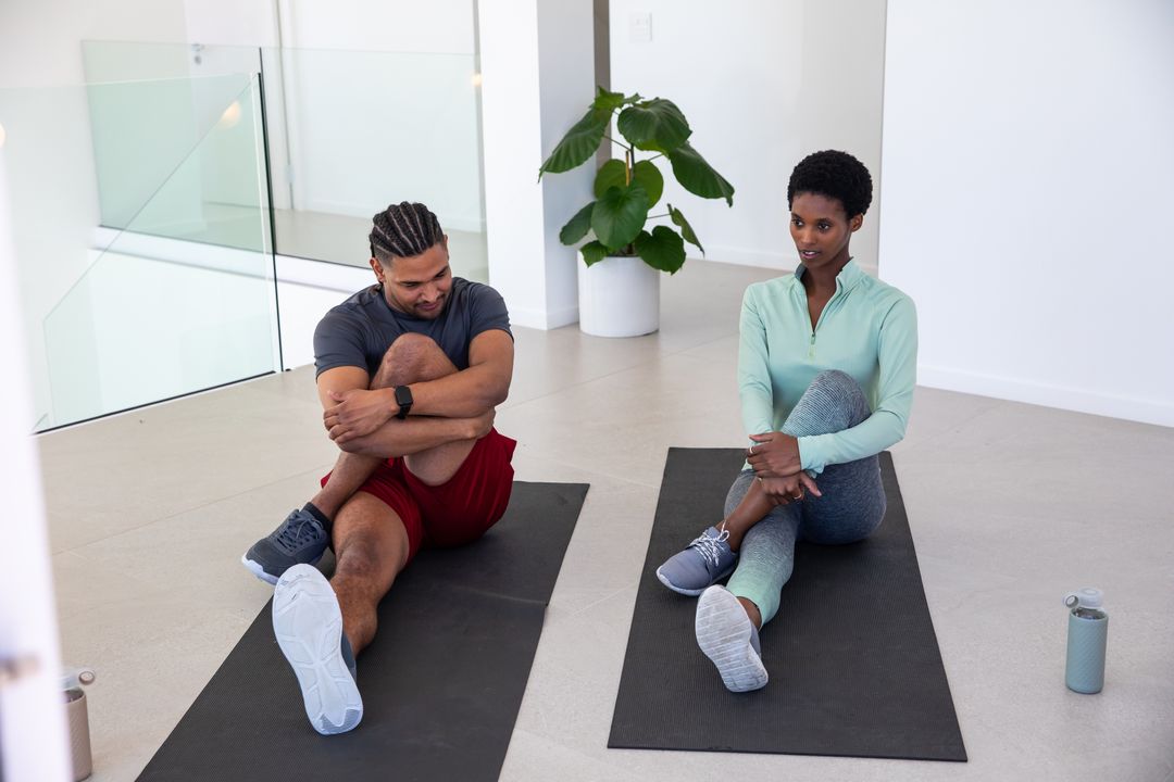 Diverse Friends Bonding Through Stretching and Fitness in Modern Space