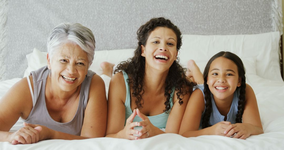 Multigenerational Family of Women Smiling and Laughing on Bed - Free Images, Stock Photos and Pictures on Pikwizard.com