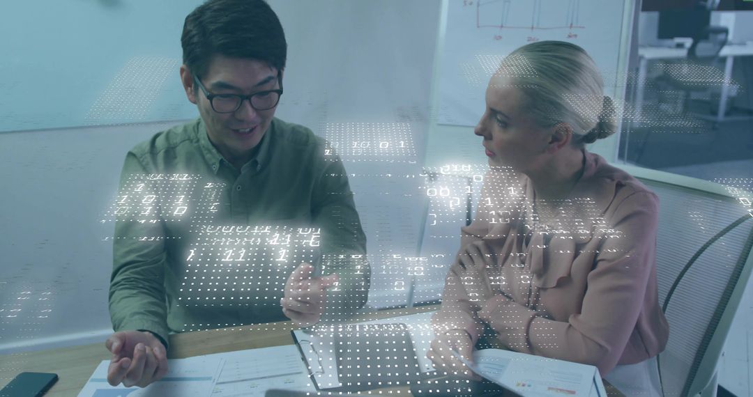 Colleagues Collaborating on Data in Modern Office with Digital Interface