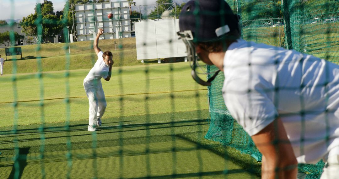 Cricketer Practicing in Nets with Coach Observing - Free Images, Stock Photos and Pictures on Pikwizard.com