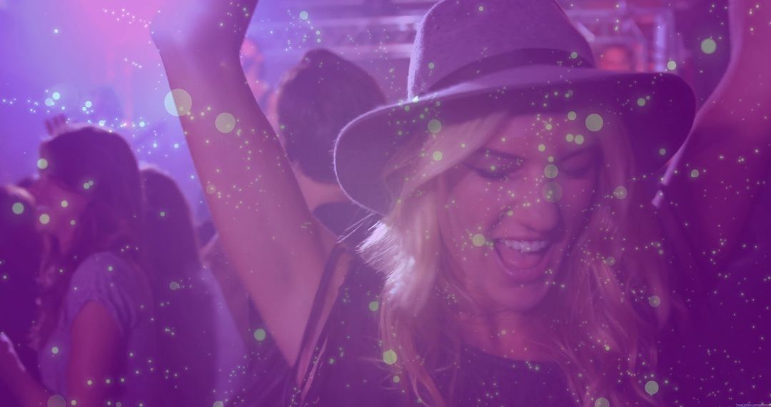 Joyful Woman in Hat Dancing at Club Celebration