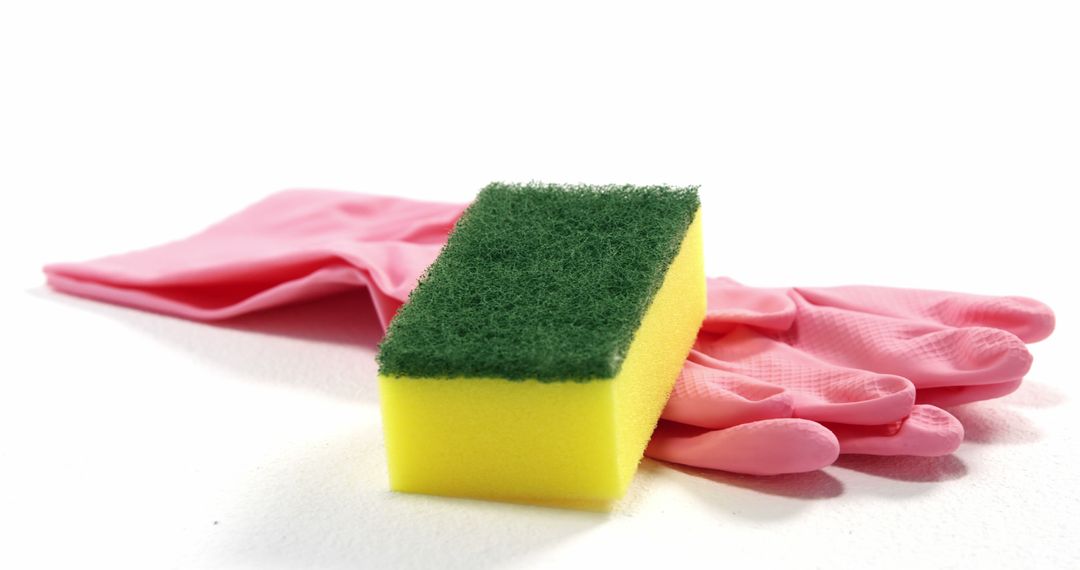 Cleaning Supplies on White Background with Kitchen Sponge and Rubber Gloves - Free Images, Stock Photos and Pictures on Pikwizard.com