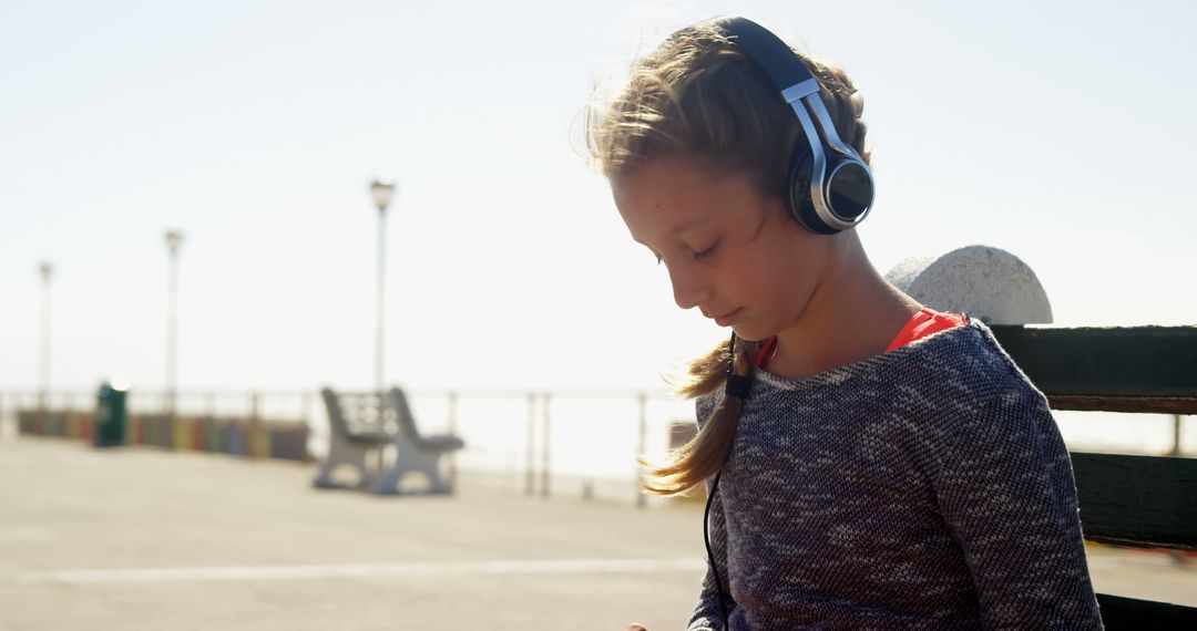 Young Girl Enjoying Music on Promenade with Headphones - Free Images, Stock Photos and Pictures on Pikwizard.com