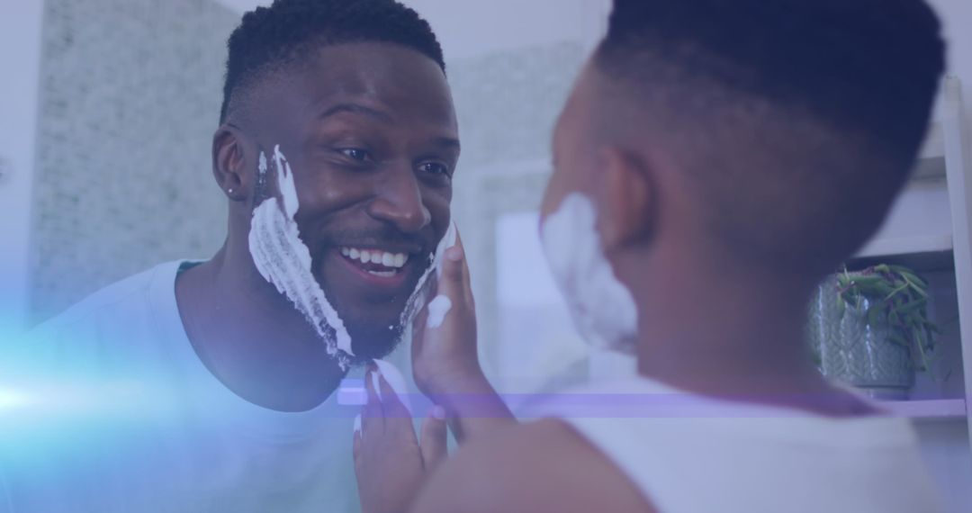 Father and Son Smiling While Shaving Together