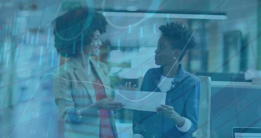 Diverse Professionals Discussing Financial Charts in Modern Office