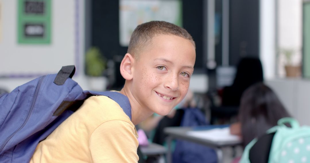 Smiling Boy with Backpack in Classroom Highlighting Diversity