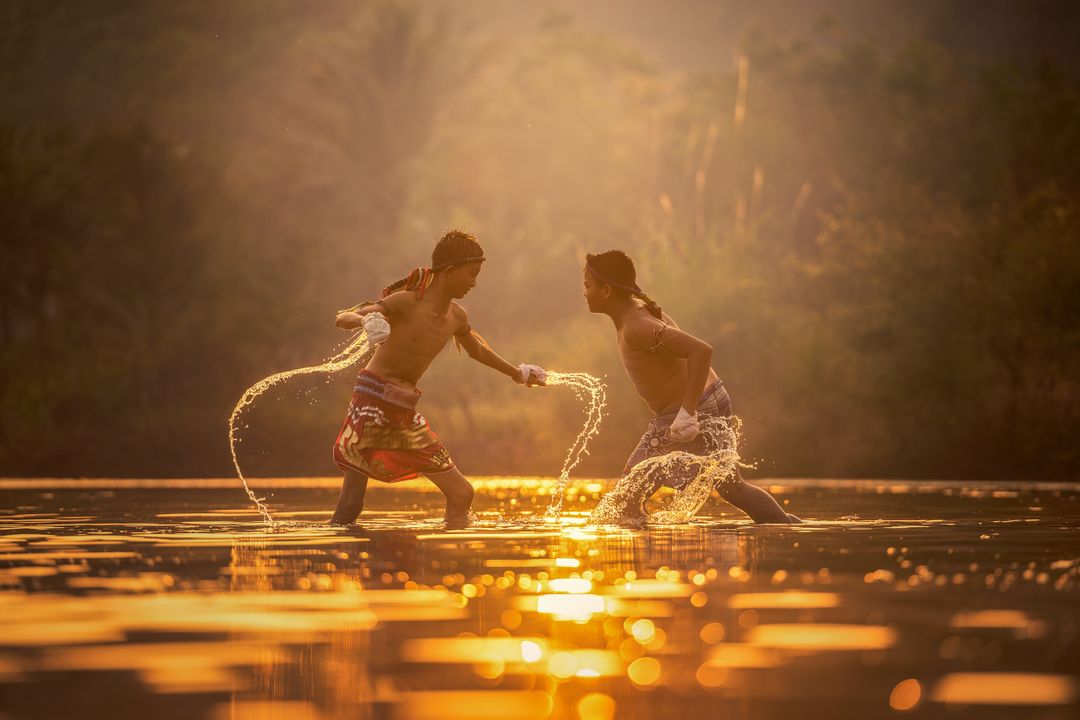 Children Splashing Water at Sunset in Countryside - Free Images, Stock Photos and Pictures on Pikwizard.com