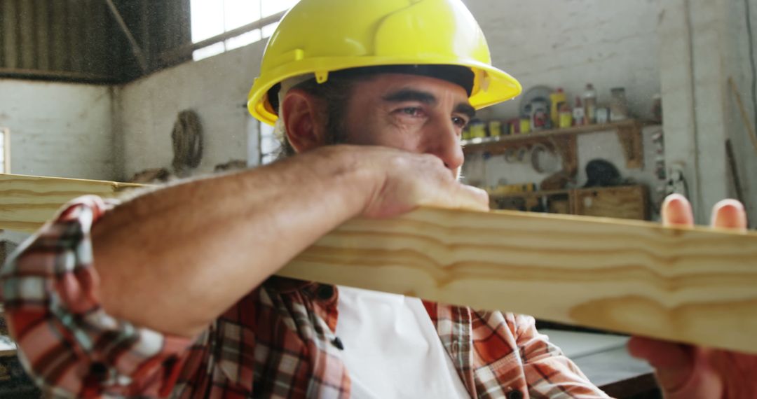 Carpenter Inspecting Wooden Plank in Workshop - Free Images, Stock Photos and Pictures on Pikwizard.com