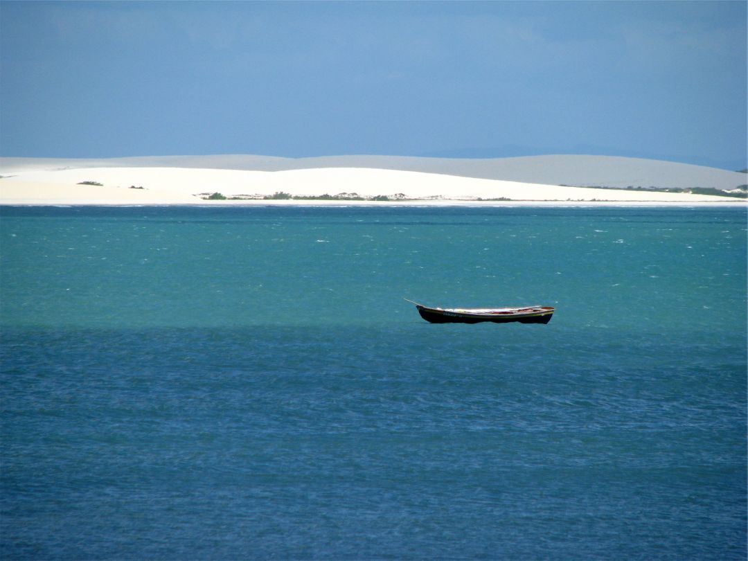 Solitary Wooden Boat Floating on Clear Blue Ocean - Free Images, Stock Photos and Pictures on Pikwizard.com