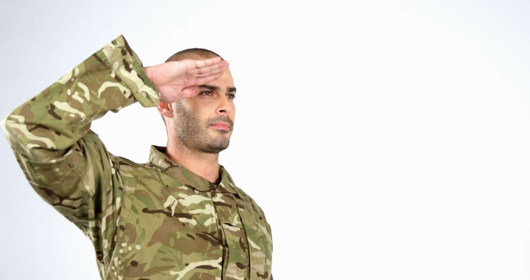 Military Soldier in Camouflage Uniform Saluting with Honor