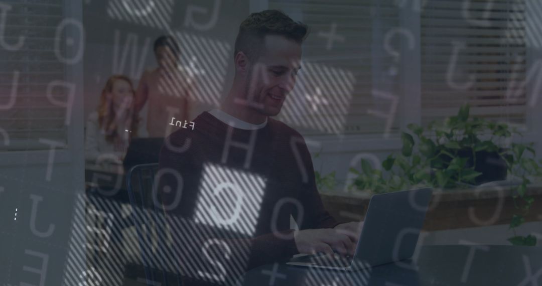 Focused Professional Typing on Laptop with Team in Modern Office