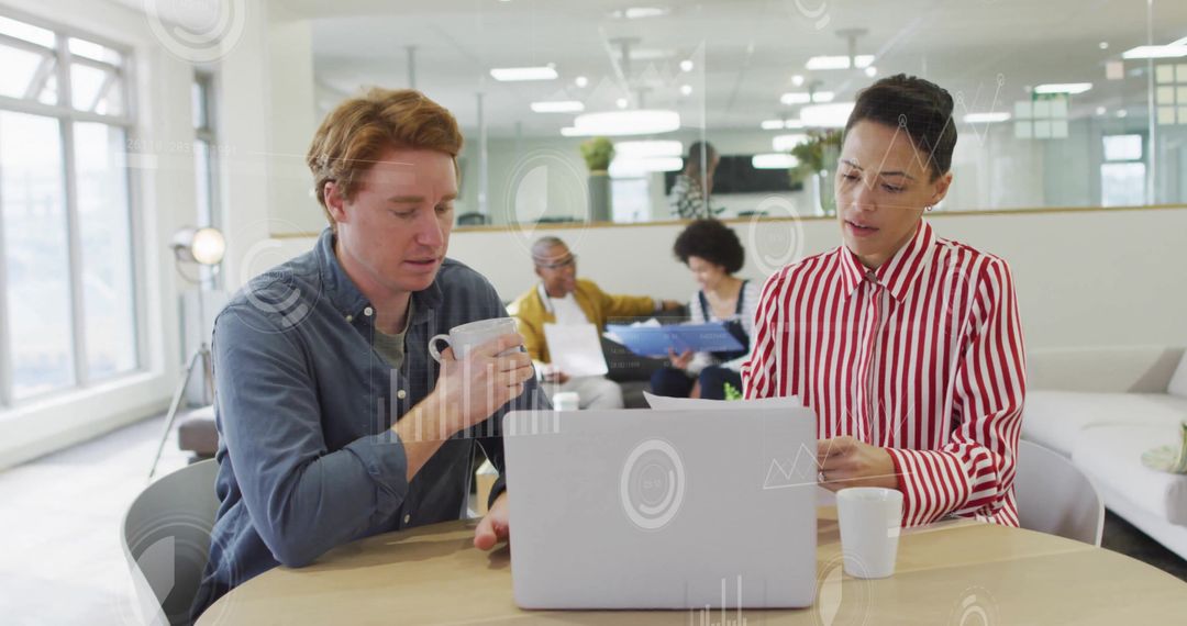 Diverse Colleagues Collaborate in Modern Office with Digital Interface