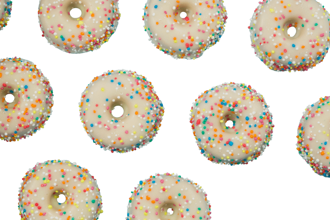 White Cream Iced Mini Donuts with Colorful Sprinkles on Transparent Background