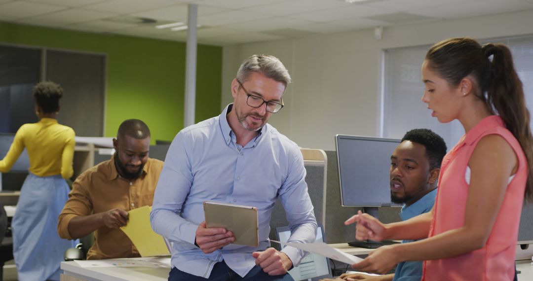 Diverse Team Collaborates with Digital Technology in Office