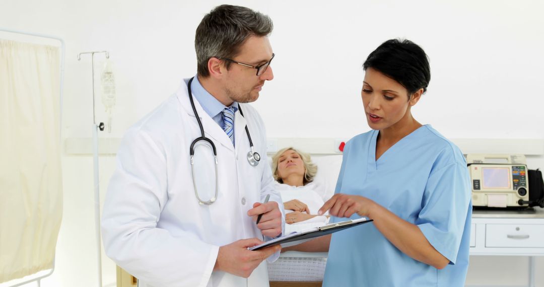 Doctors Discussing Patient's Medical Records in Hospital Room - Free Images, Stock Photos and Pictures on Pikwizard.com