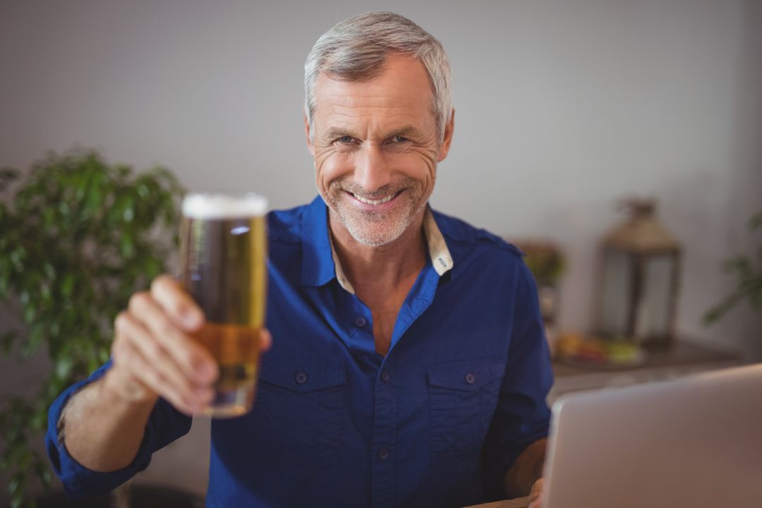 Portrait of mature man holding beer glass - Free Images, Stock Photos and Pictures on Pikwizard.com