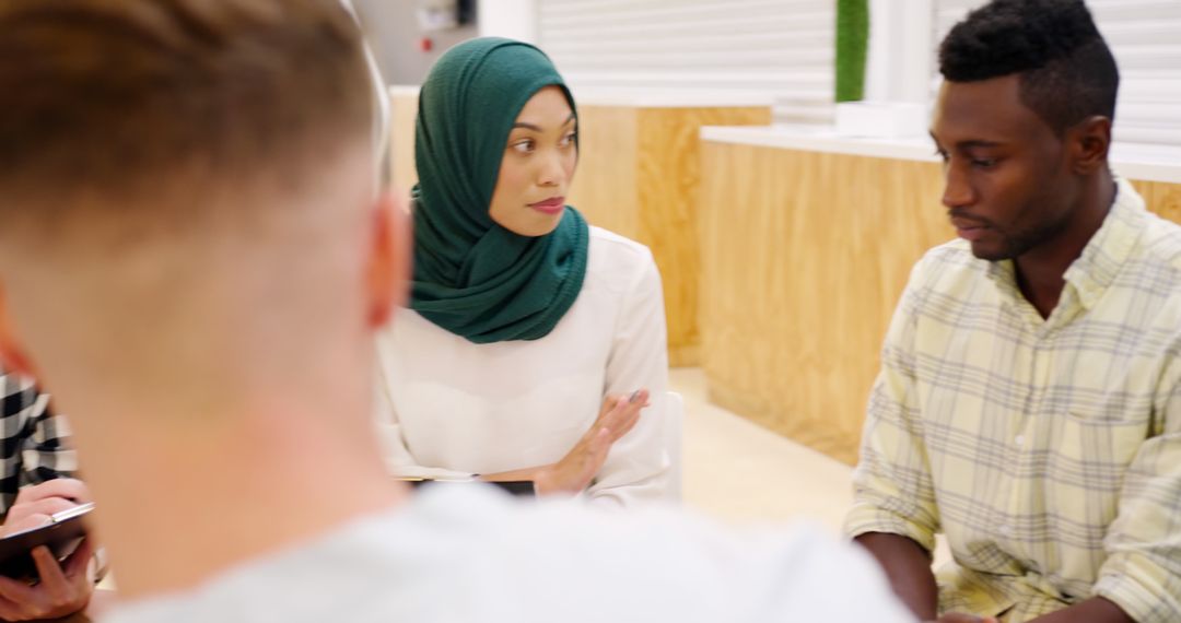 Diverse young professionals collaborating in modern office setting