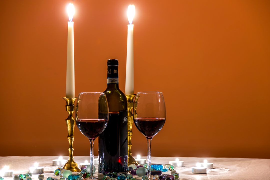 Romantic Dinner Setting with Candles and Red Wine