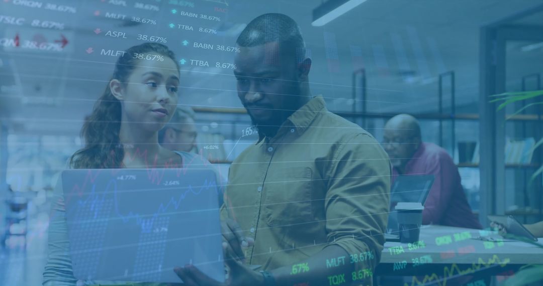 Successful Diverse Team Analyzing Financial Data on Laptop