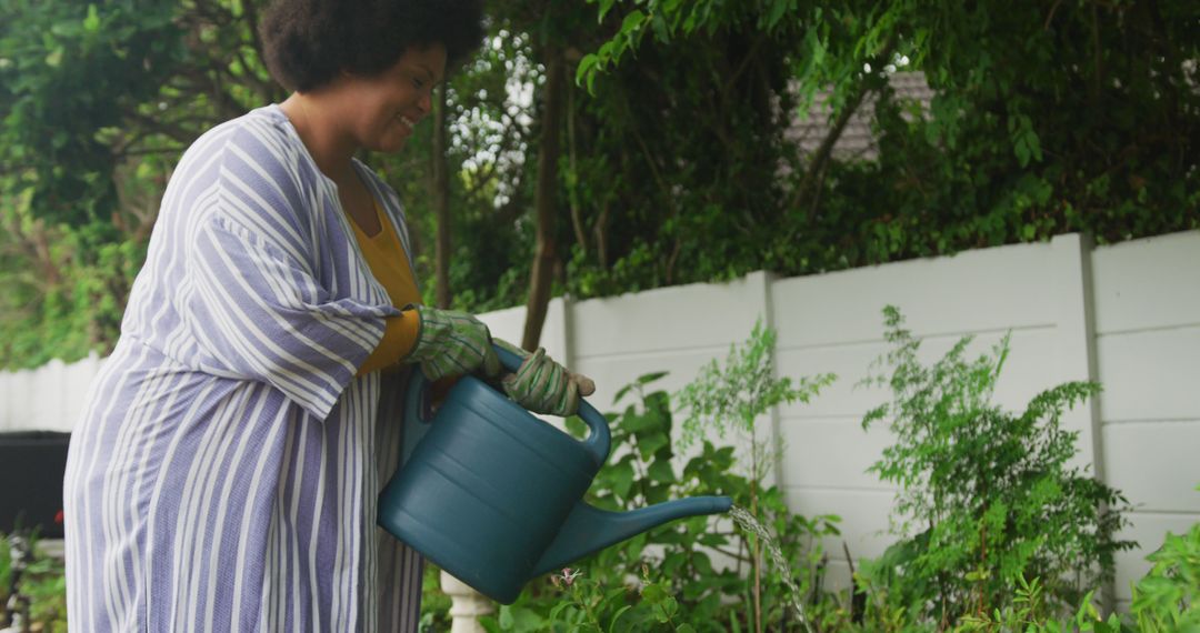 Woman Watering Plants in a Home Garden - Free Images, Stock Photos and Pictures on Pikwizard.com
