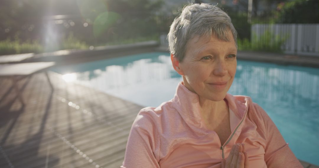 Senior Woman Meditating by Pool with Serene Expression - Free Images, Stock Photos and Pictures on Pikwizard.com