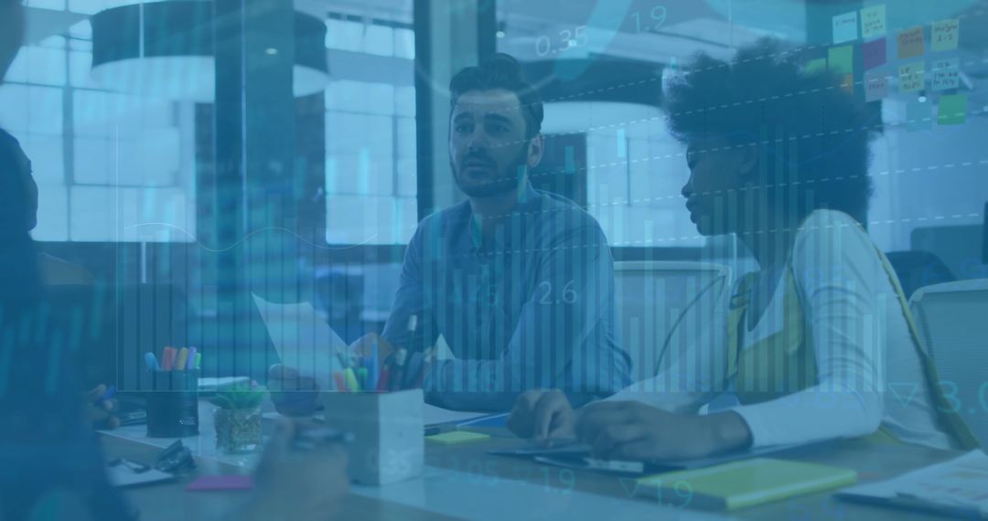 Diverse Team Reviewing Financial Data with Digital Interface in Office