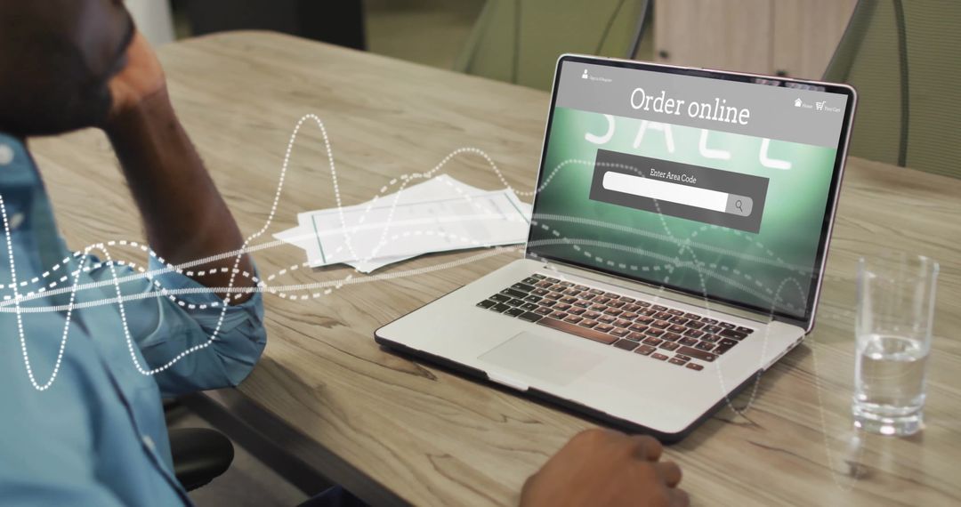 Man Ordering Online from Laptop with E-commerce Interface