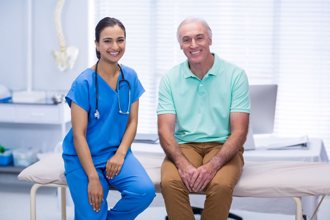 Smiling Doctor with Senior Patient in Clinic - Free Images, Stock Photos and Pictures on Pikwizard.com