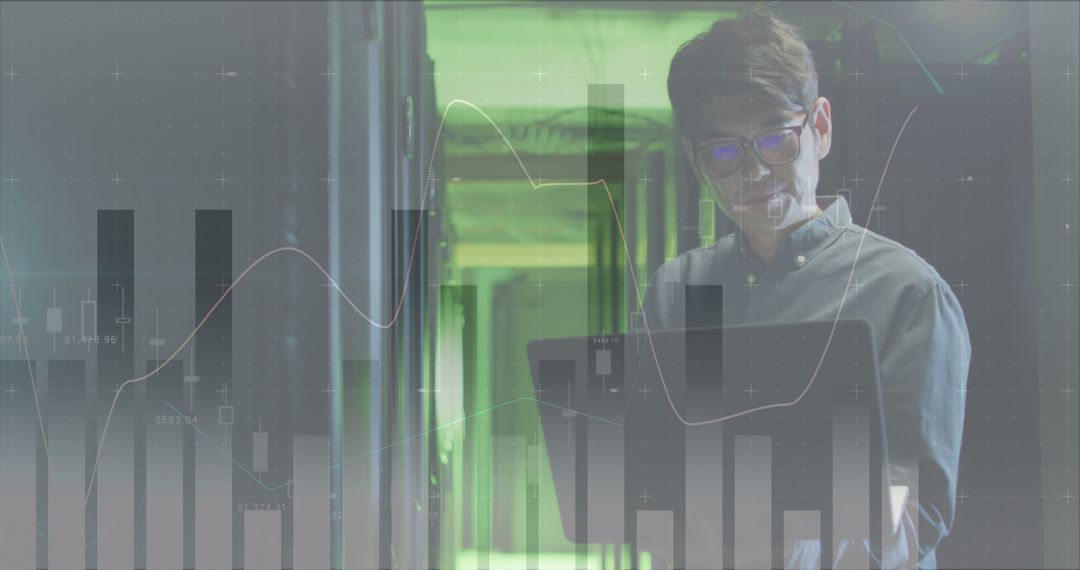 Asian Male IT Engineer with Laptop in Data Center