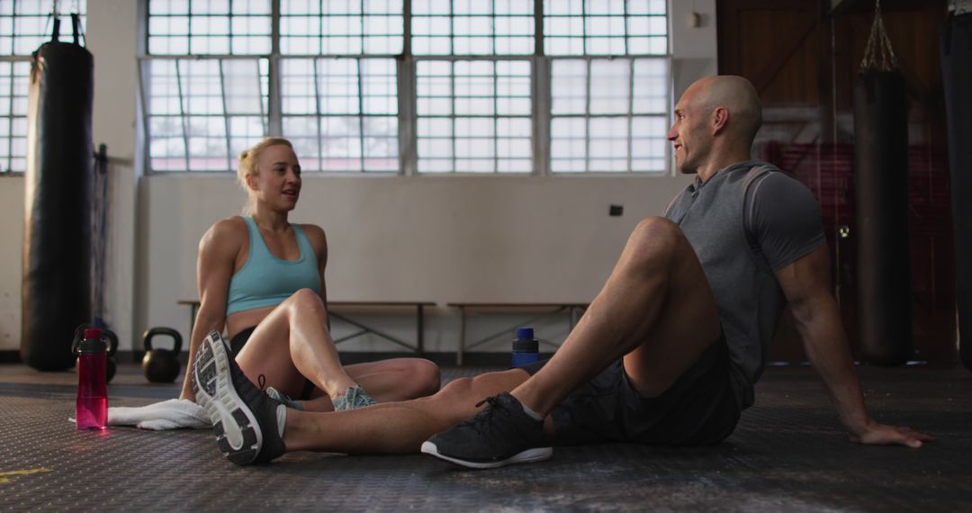 Two Athletes Resting After Intense Workout Session in Gym - Free Images, Stock Photos and Pictures on Pikwizard.com