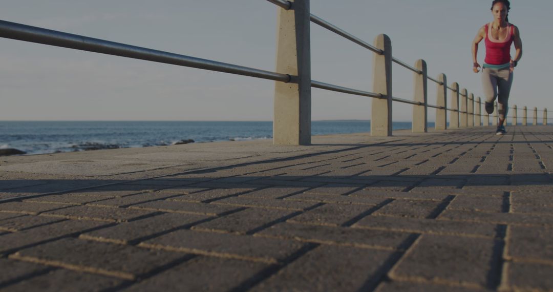 Woman Running Along Ocean Promenade