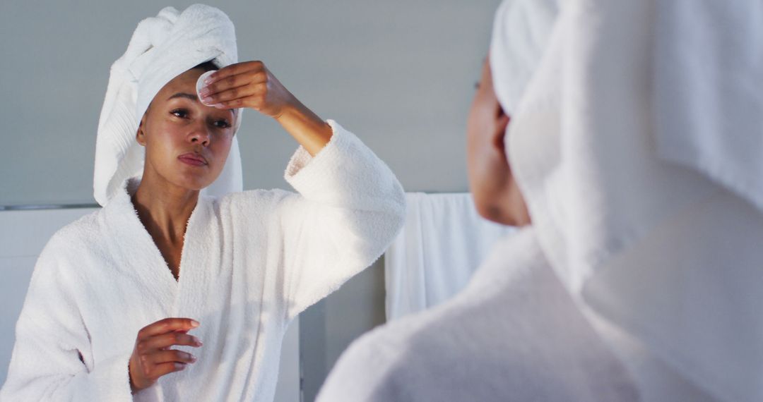 Woman Cleansing Face in Mirror with Soft Towel on Head - Free Images, Stock Photos and Pictures on Pikwizard.com