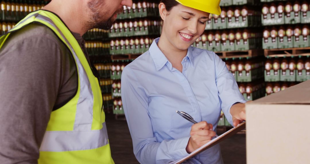 Warehouse Workers Managing Inventory with Clipboard - Free Images, Stock Photos and Pictures on Pikwizard.com