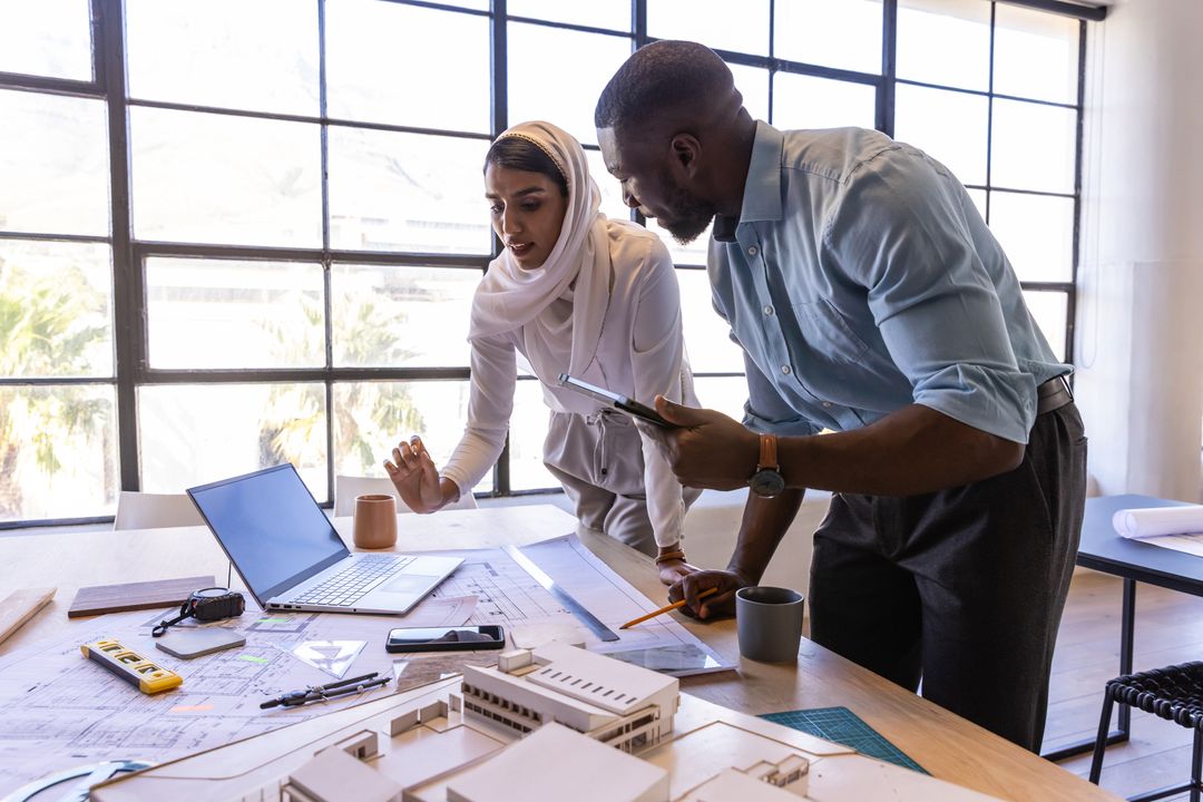 Diverse Coworkers Collaborating on Architectural Project in Modern Studio