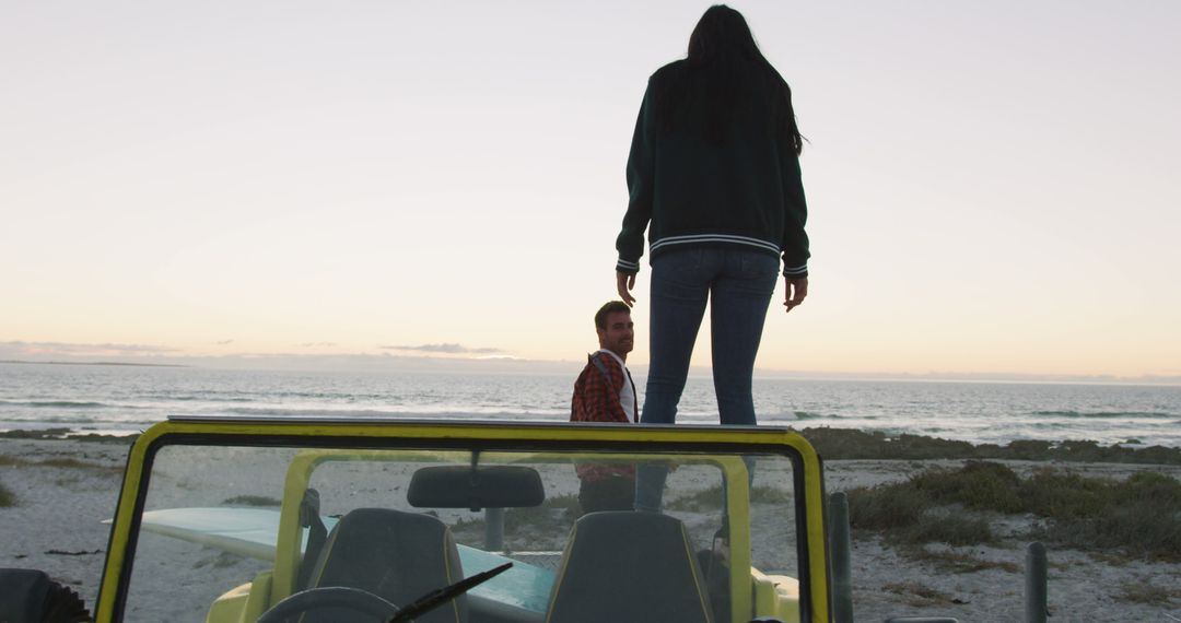 Friends Enjoying Sunset at a Beach with a Jeep in Foreground - Free Images, Stock Photos and Pictures on Pikwizard.com