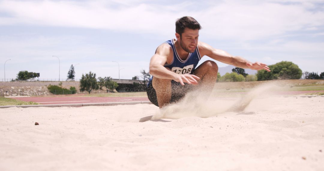 Athlete Landing Long Jump on Sand at Track and Field Outdoor