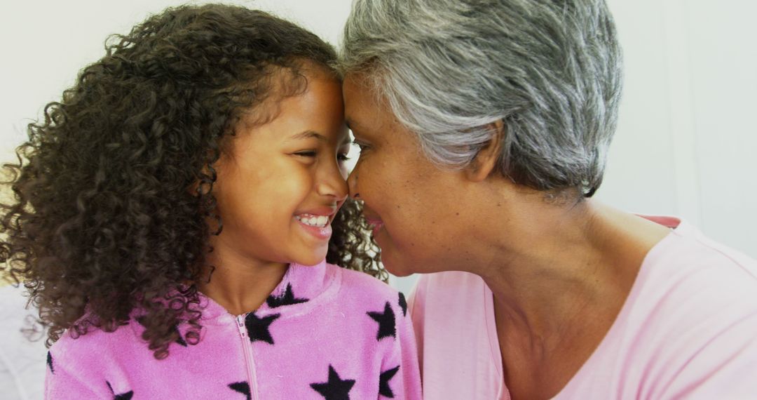 Grandmother and Granddaughter Smiling and Hugging Indoors - Free Images, Stock Photos and Pictures on Pikwizard.com