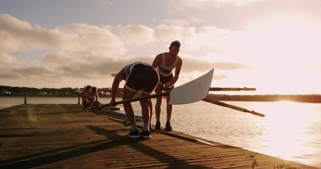 Rowers Preparing Boat on Dock at Sunrise - Free Images, Stock Photos and Pictures on Pikwizard.com