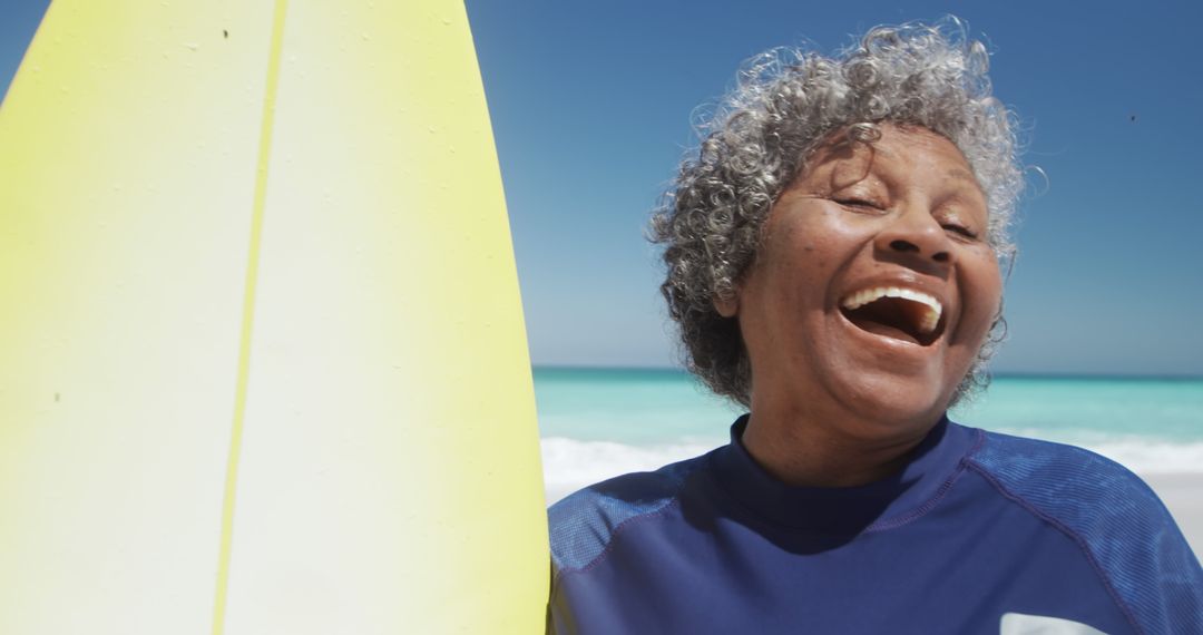 Elderly Woman Enjoying Surfing on Sunny Day at Beach - Free Images, Stock Photos and Pictures on Pikwizard.com