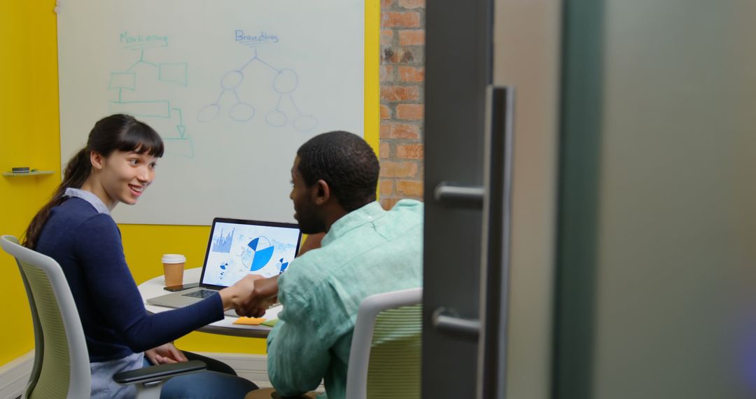 Diverse Team Collaborating on Business Charts in Modern Office