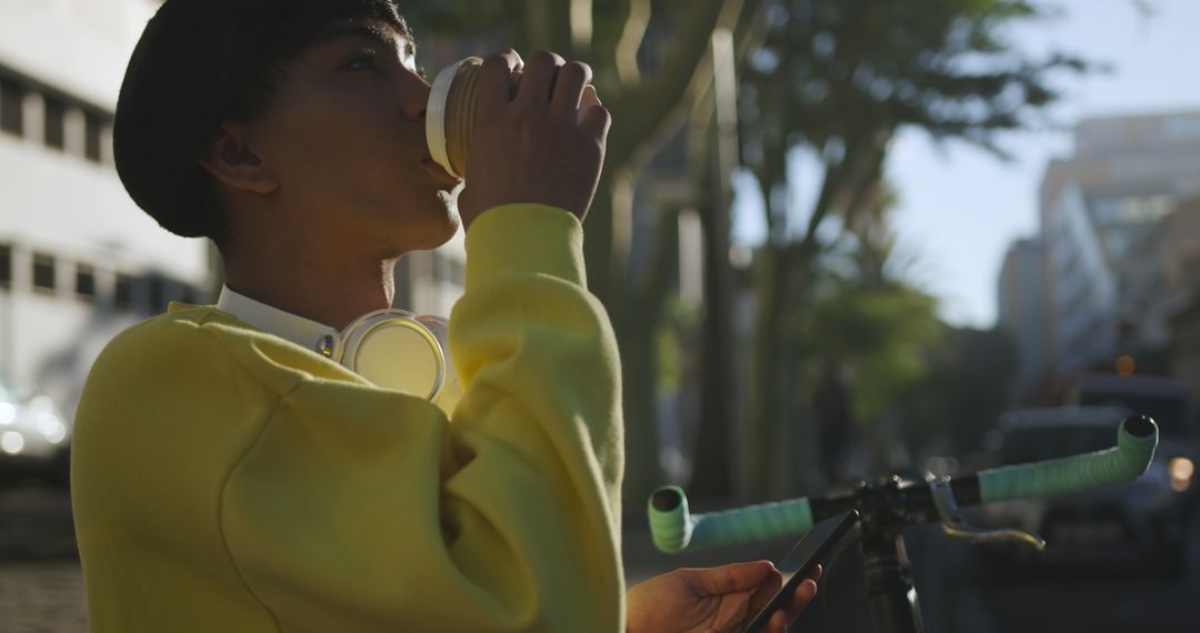 Young man drinking coffee while outdoors with a bicycle - Free Images, Stock Photos and Pictures on Pikwizard.com