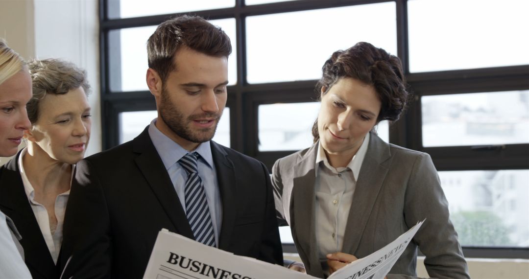 Business Team Reading Newspaper Together in Office - Free Images, Stock Photos and Pictures on Pikwizard.com