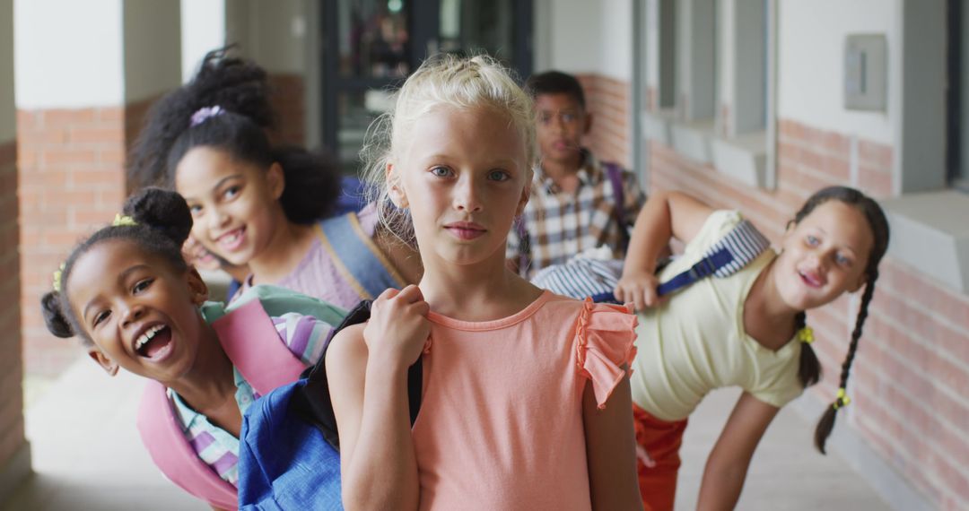 Image of happy caucasian girl and diverse pupils at schoot corridor - Free Images, Stock Photos and Pictures on Pikwizard.com