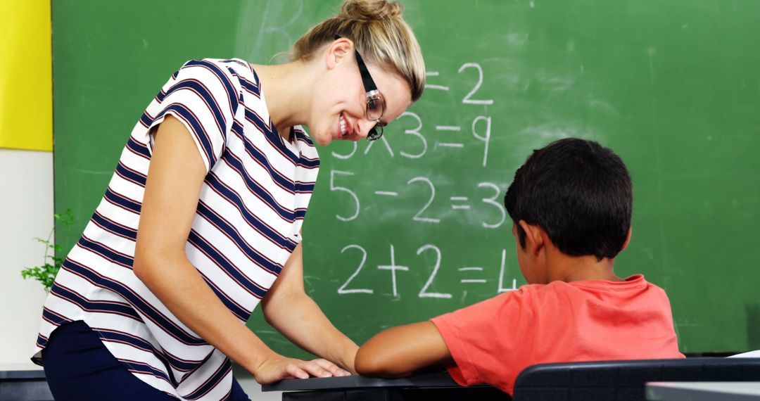 Teacher Helping Young Student with Math in Classroom - Free Images, Stock Photos and Pictures on Pikwizard.com