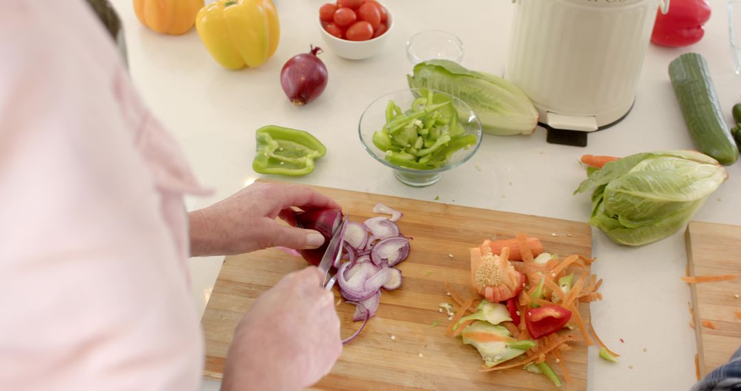 Senior Couple Preparing Fresh Vegetables in Rustic Kitchen