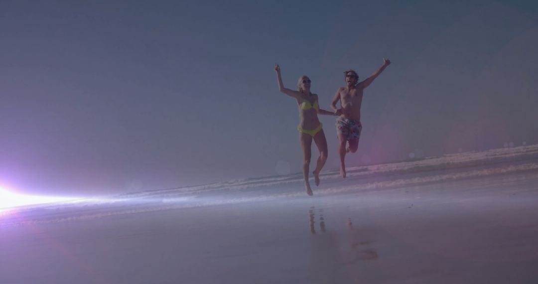 Couple Enjoying Energetic Beach Sprint at Sunset